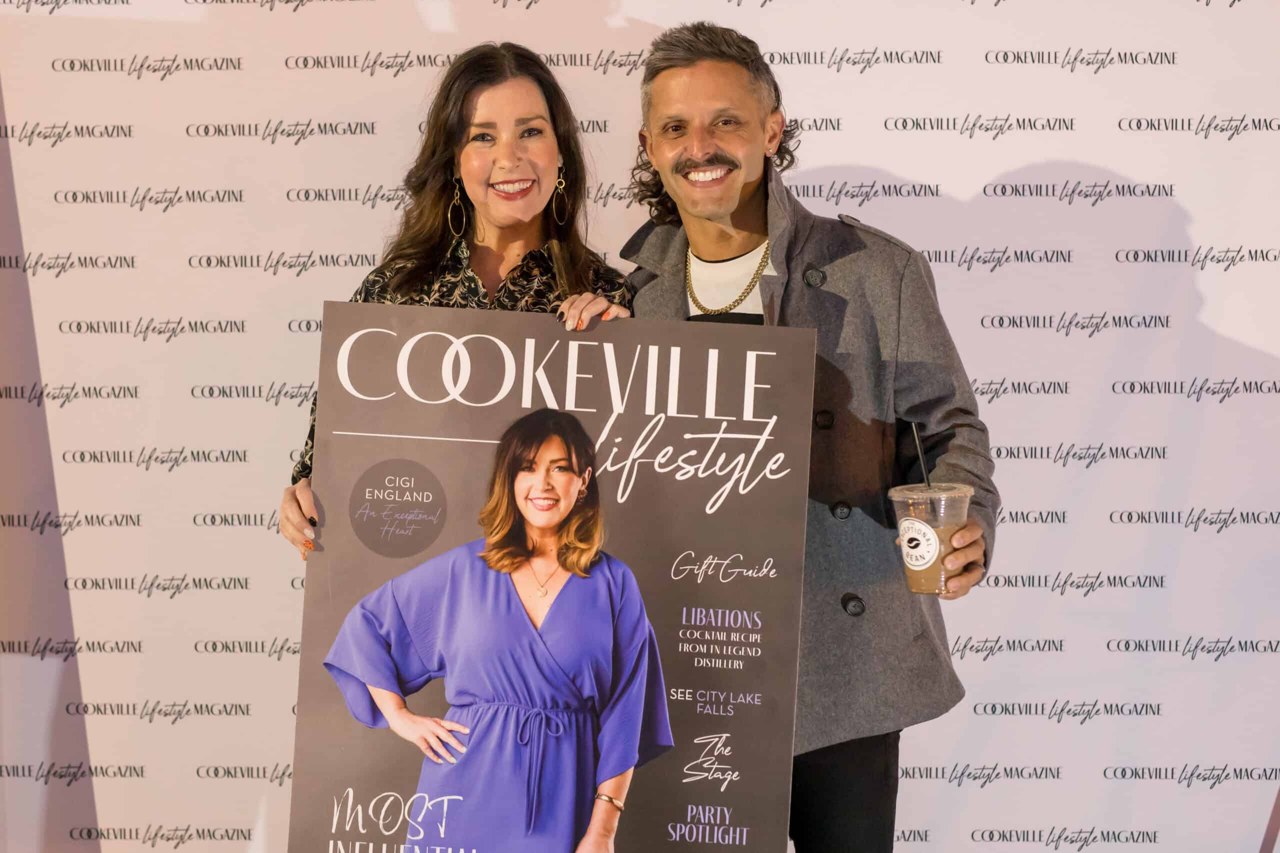 Happy attendees at the Upper Cumberland Lifestyle event holding a magazine.