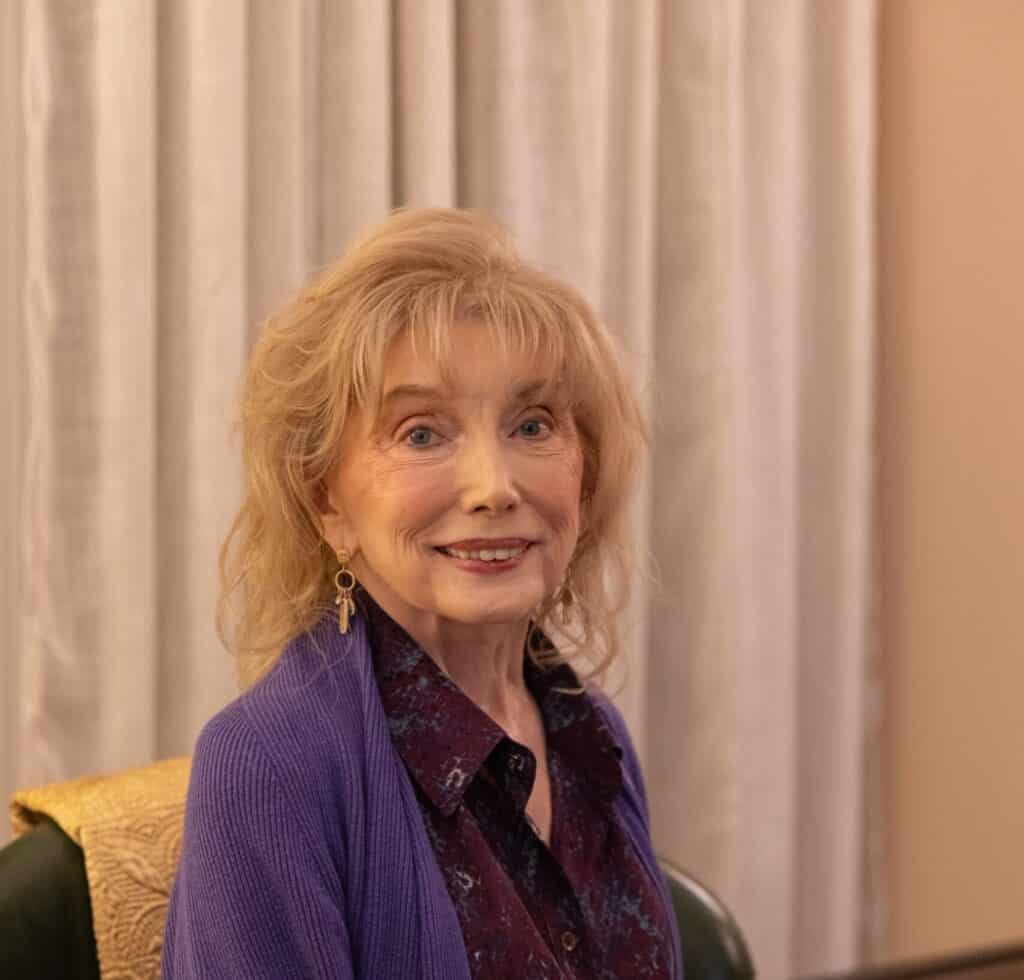 Older woman smiling at a social gathering in Upper Cumberland.
