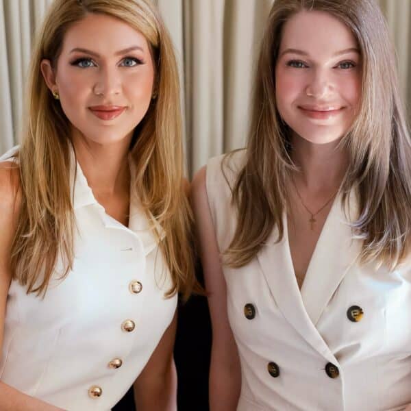 Elegant women in stylish white outfits at Upper Cumberland Lifestyle event.