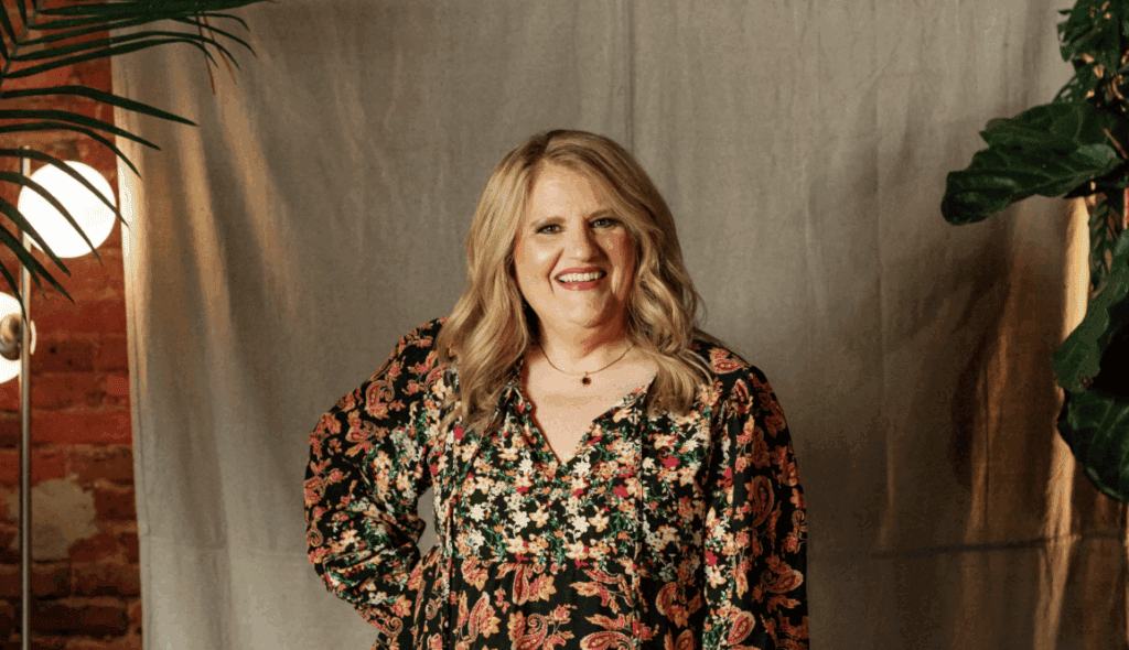 Woman smiling at Upper Cumberland Lifestyle event, showcasing community engagement and local culture.