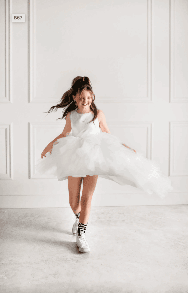 Girl spinning in a white dress, showcasing Upper Cumberland Lifestyle.