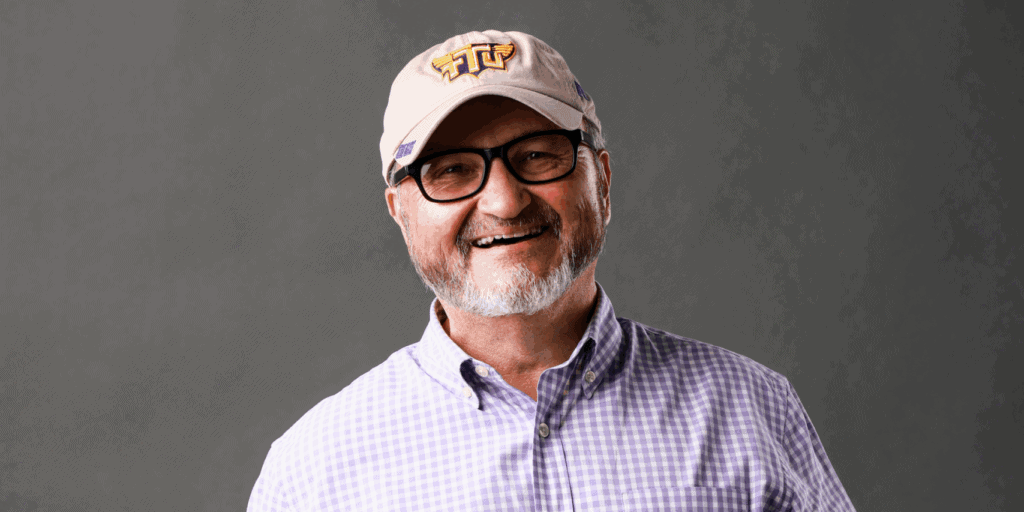 Man smiling with glasses and a cap, representing the friendly community of Upper Cumberland.