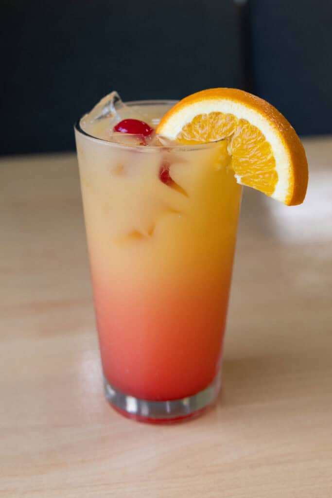 Colorful citrus cocktail with orange slice and cherries, perfect for Upper Cumberland lifestyle.