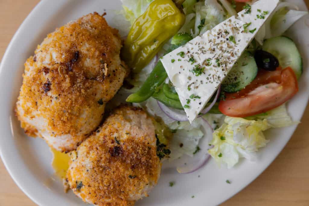 Delicious fried chicken with fresh salad and vegetables, showcasing local cuisine and healthy eating.