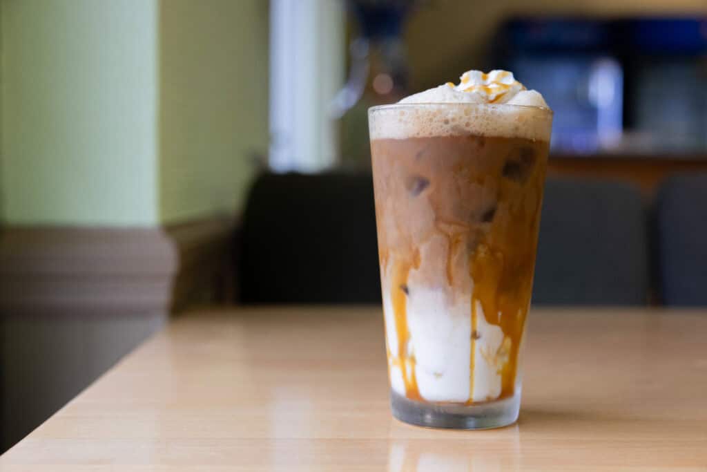 Creamy caramel iced coffee with whipped cream, perfect for summer refreshment.
