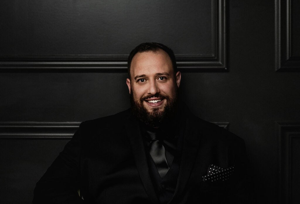Man in black suit smiling at Upper Cumberland Lifestyle event.
