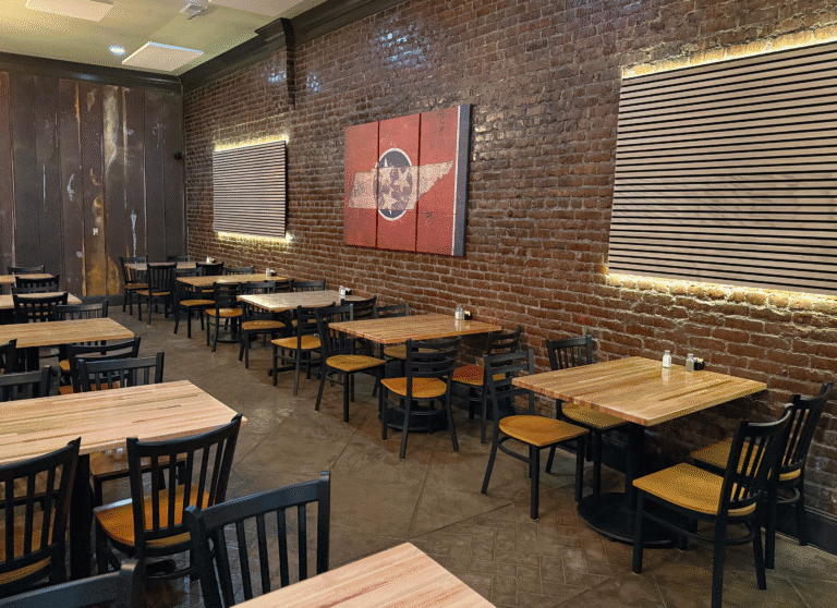 Interior of a Tennessee restaurant with brick walls and wooden tables.