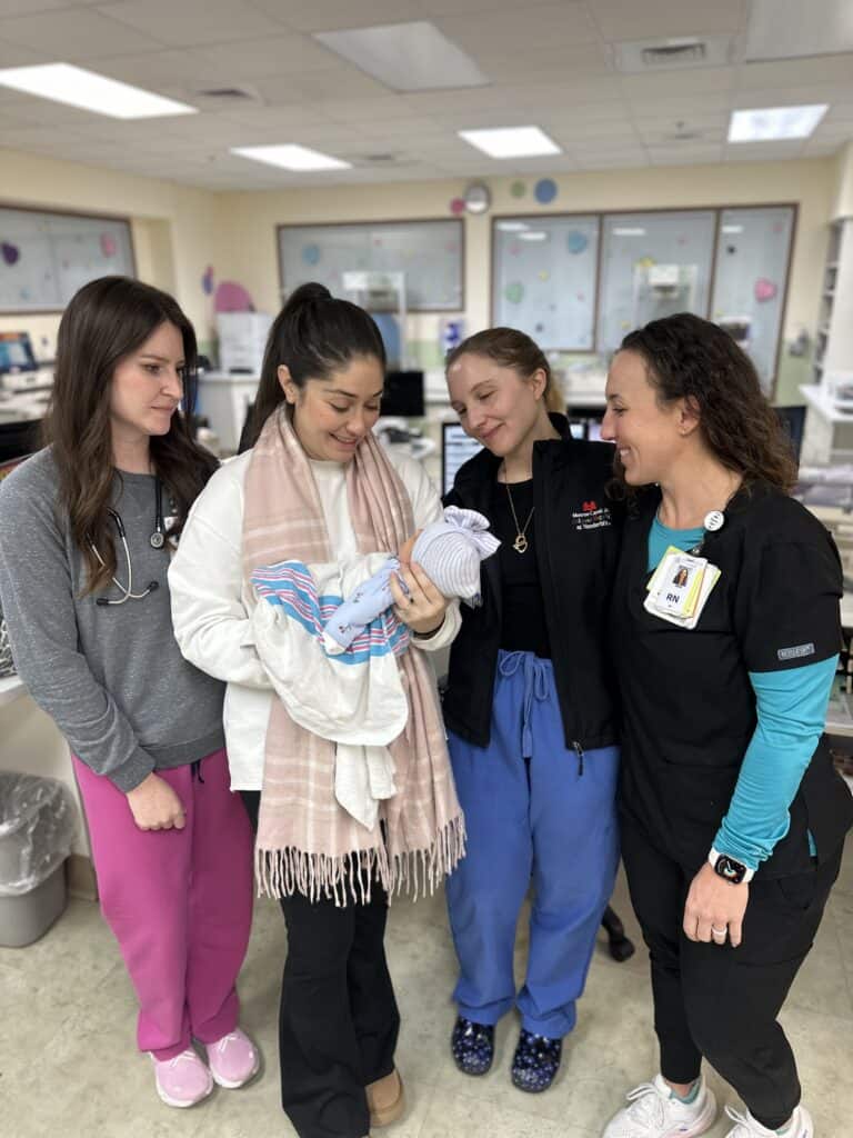 nurses and doctors with new mom and baby at cookeville regional hospital after emergency delivery
