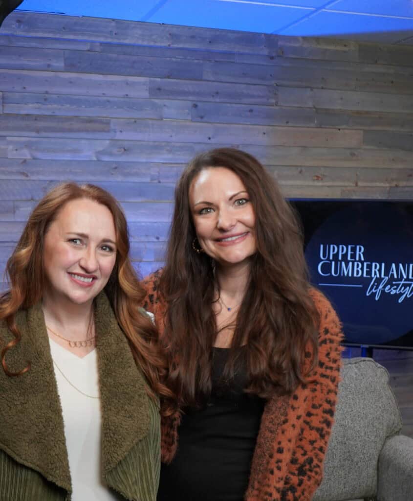 Two women smiling at an Upper Cumberland Lifestyle event.