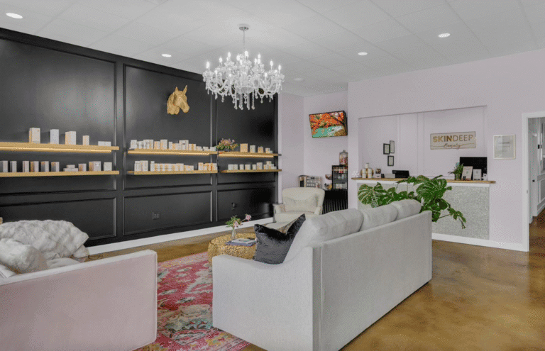 Modern spa reception area with cozy seating and elegant decor.