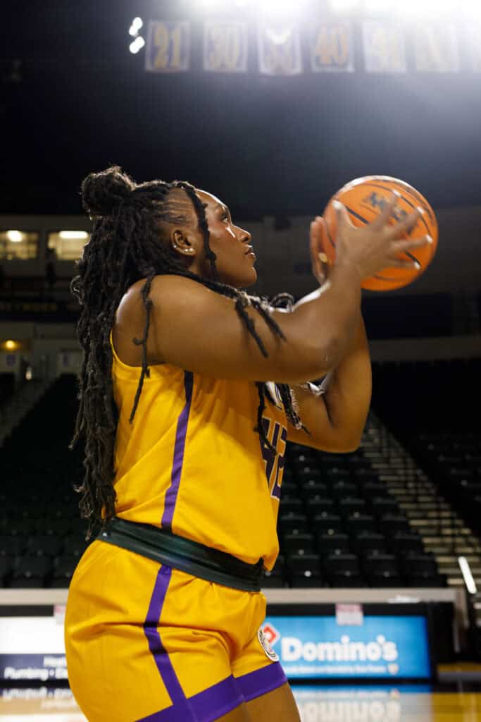 female basketball player golden eagle shooting basketball
