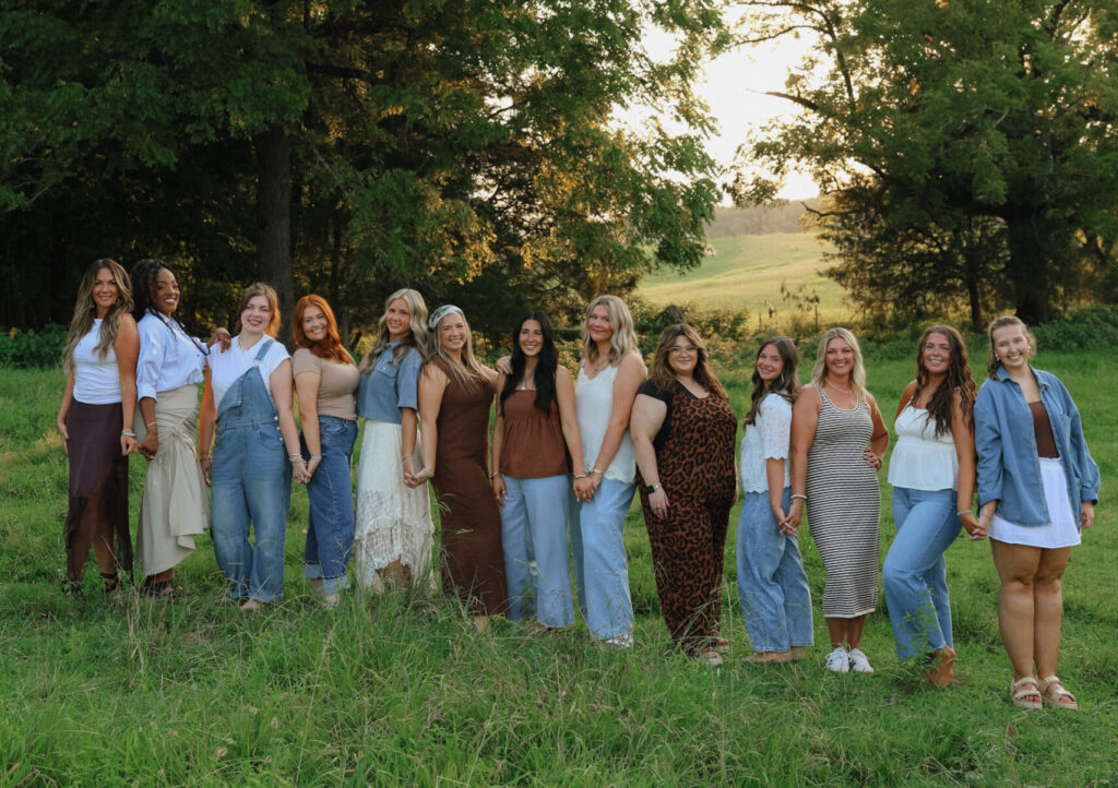 a group of women stand in a field